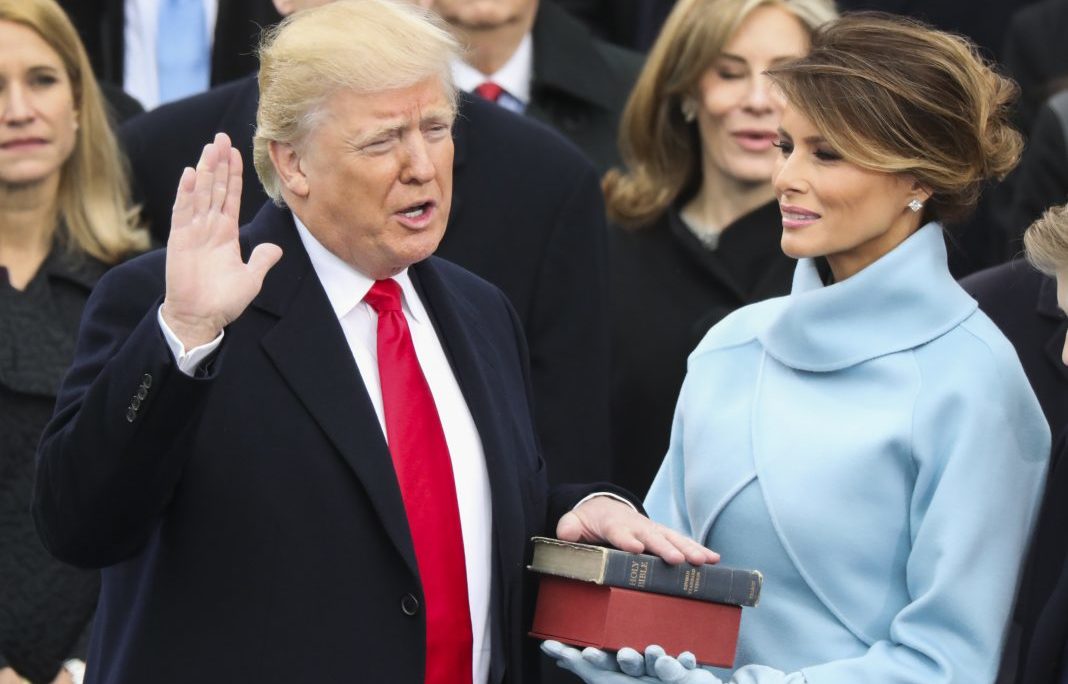 Donald Trump taking the presidential oath of office alongside Melania Trump.