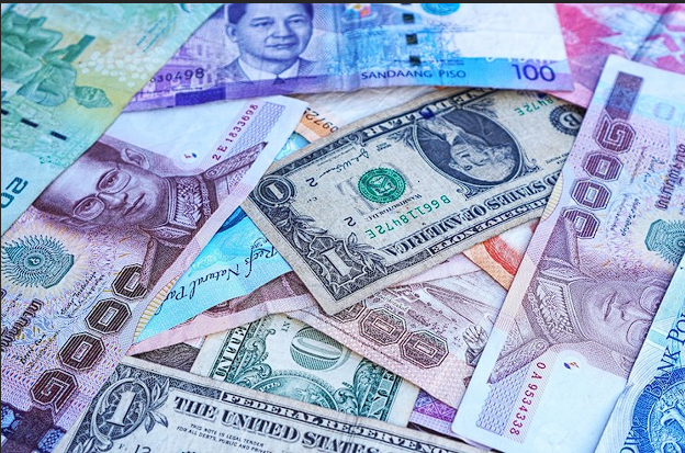 A collection of various international banknotes, including USD, Euro, and other global currencies, symbolizing forex market trends and currency trading opportunities.