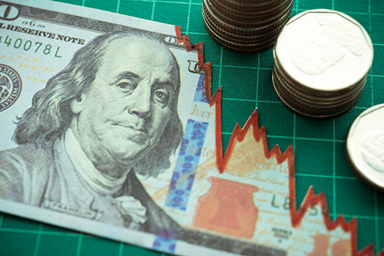 A U.S. dollar bill with a red declining graph overlay, accompanied by stacked coins, symbolizing forex market trends and currency fluctuations.